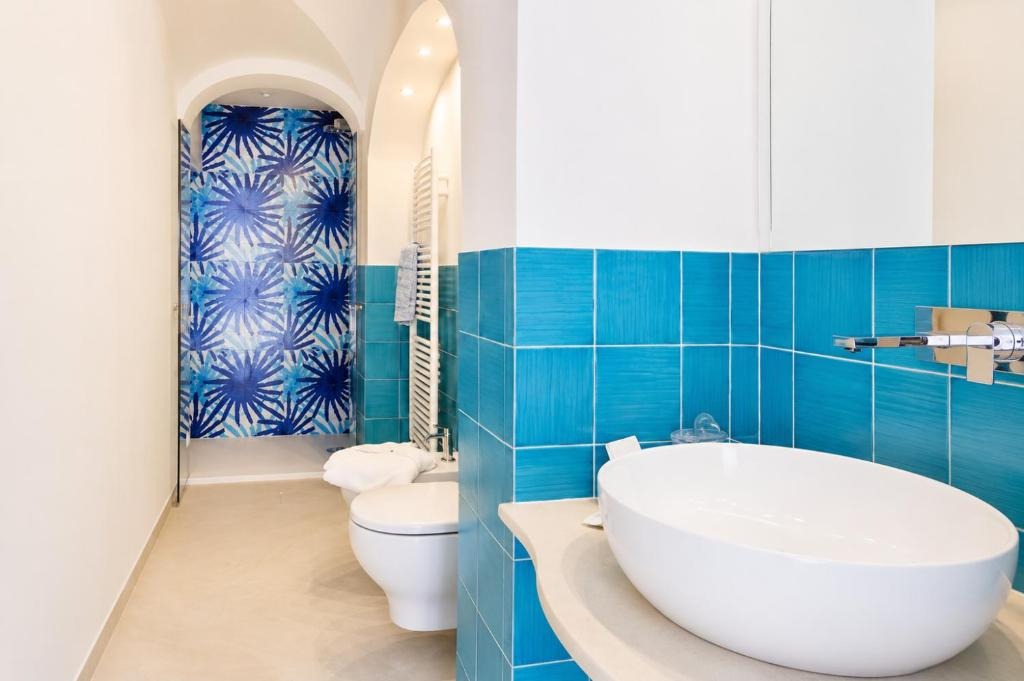 Bathroom with hand-painted blue tiles and oval sink